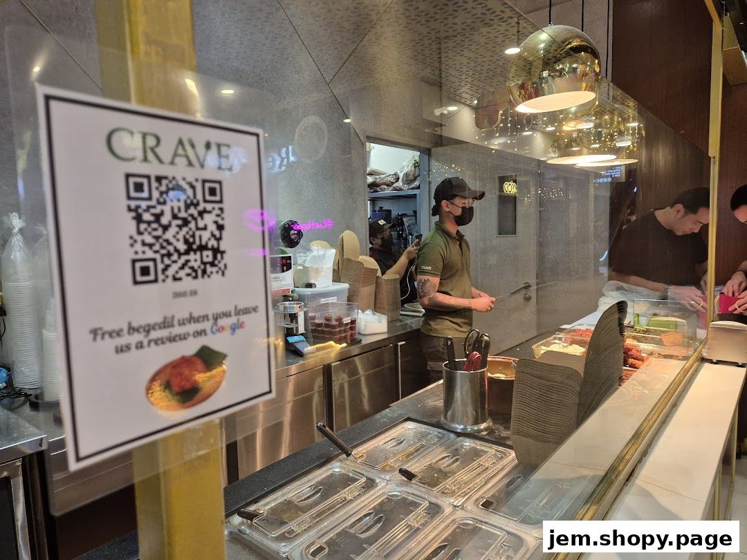 A sign offering free begedil for Google reviews at Crave Nasi Lemak.