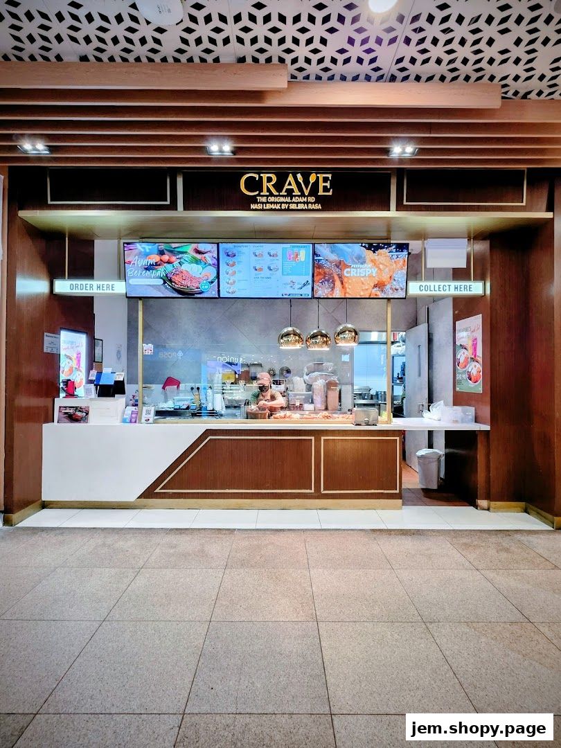 The Crave Nasi Lemak shop front with digital menus displaying food items.