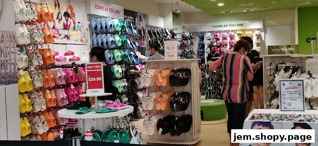 Interior of a Crocs store showcasing a wide variety of colorful clogs, sandals, and Jibbitz charms.