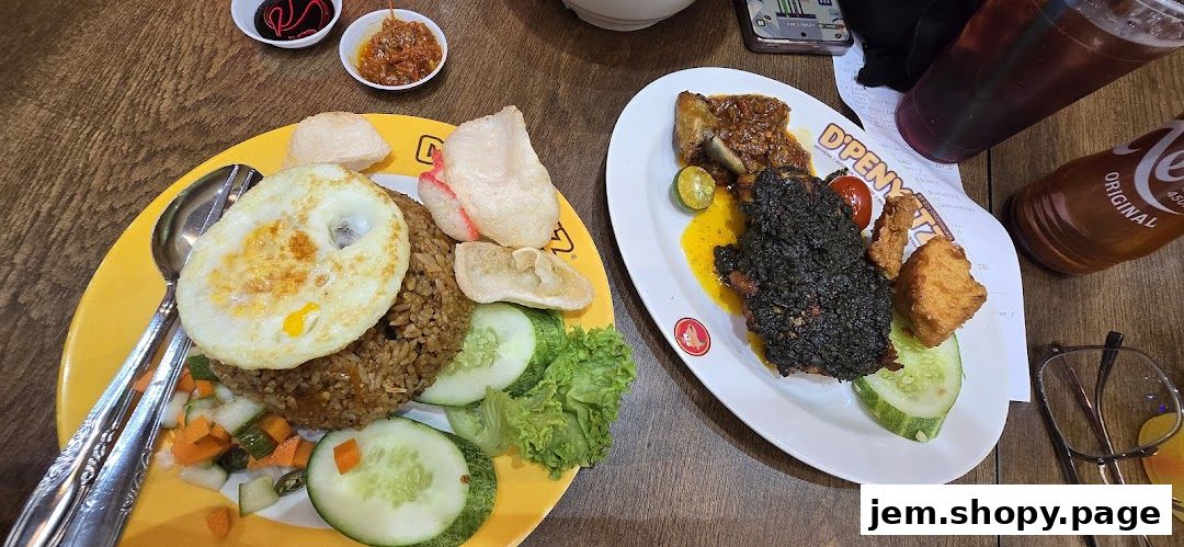 Two plates of Indonesian food, including fried rice and a dark-crusted meat dish, with drinks.
