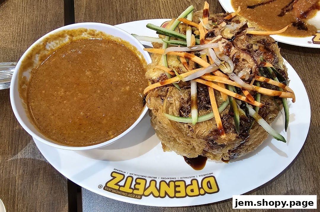 A plate of crispy fried food with peanut sauce and fresh vegetable toppings.