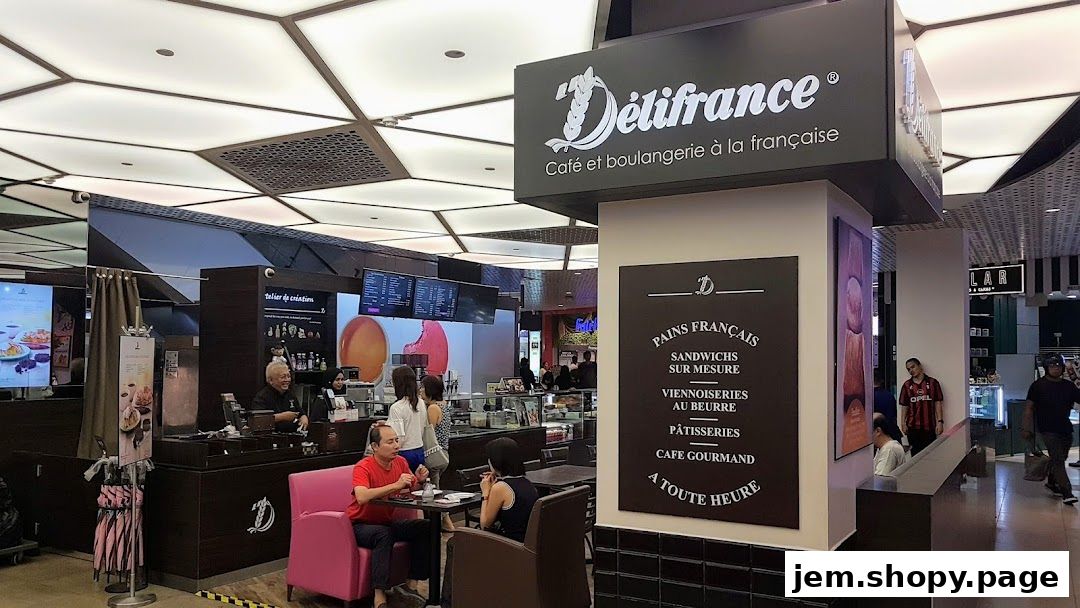 Exterior view of Délifrance cafe and bakery with a menu board and seating area.