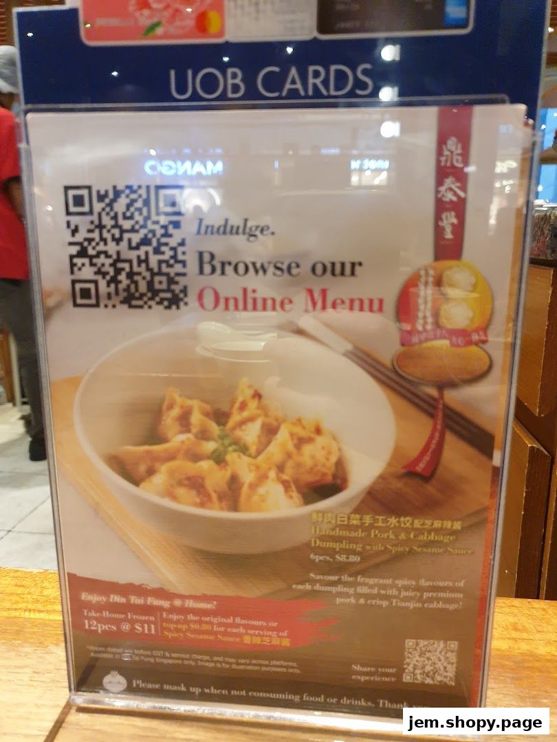 A sign for Din Tai Fung's online menu featuring pork and cabbage dumplings.