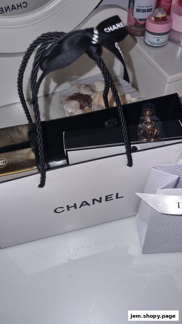 Chanel shopping bag with perfume and jewelry, alongside Dior packaging.