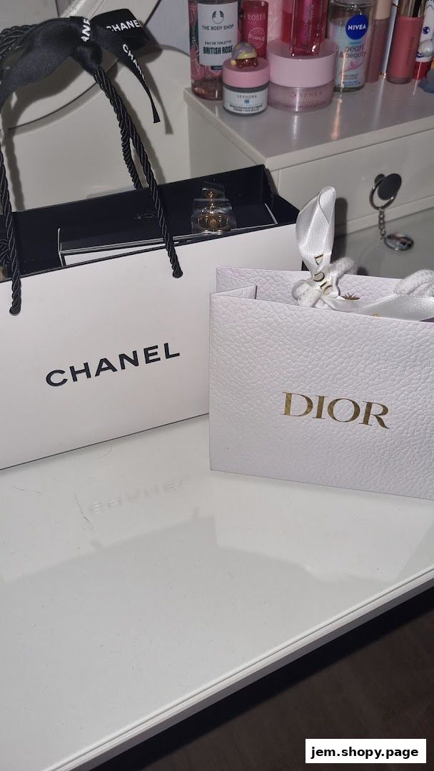 Chanel and Dior shopping bags with perfume and beauty products on a vanity.