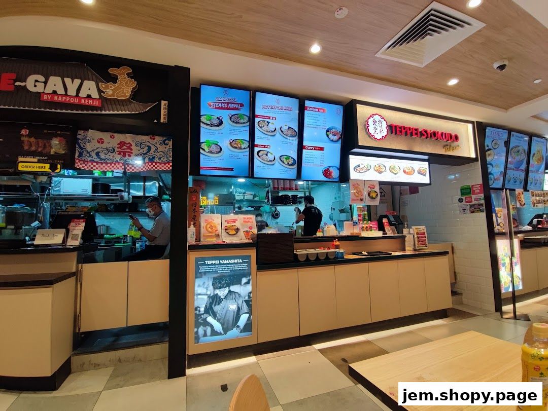 A food court with multiple Japanese food stalls, including Teppei Syokudo and E-Gaya.