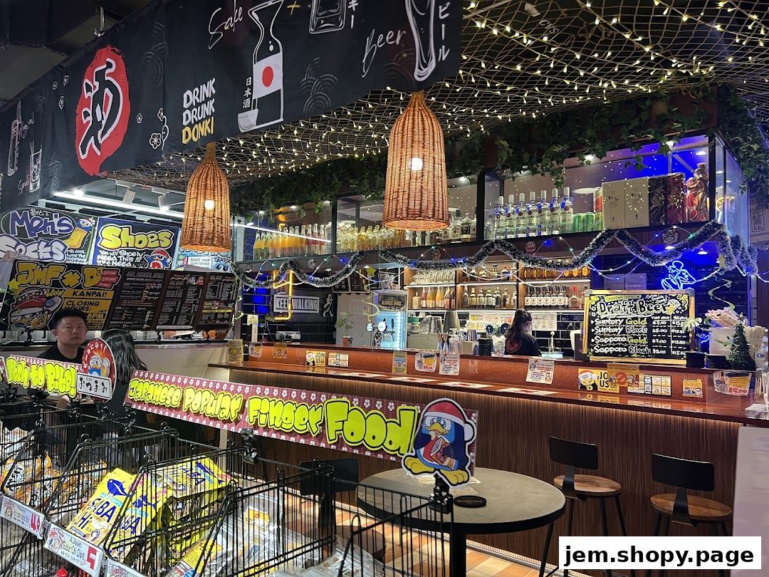 Interior view of a Don Don Donki store with a bar area, shelves of drinks, and food displays.