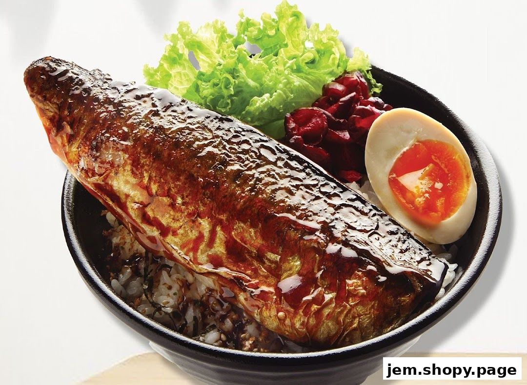 A delicious bowl of rice topped with a glazed grilled fish, egg, and salad.