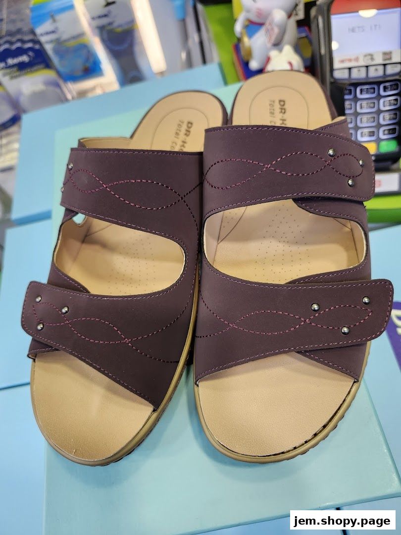 A pair of stylish, comfortable-looking burgundy sandals with adjustable straps.