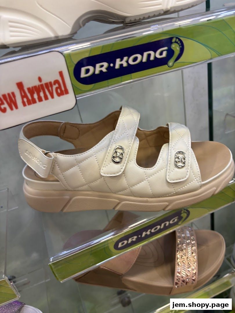 A display of Dr. Kong brand sandals, featuring a white quilted sandal and a rose gold embellished sandal.