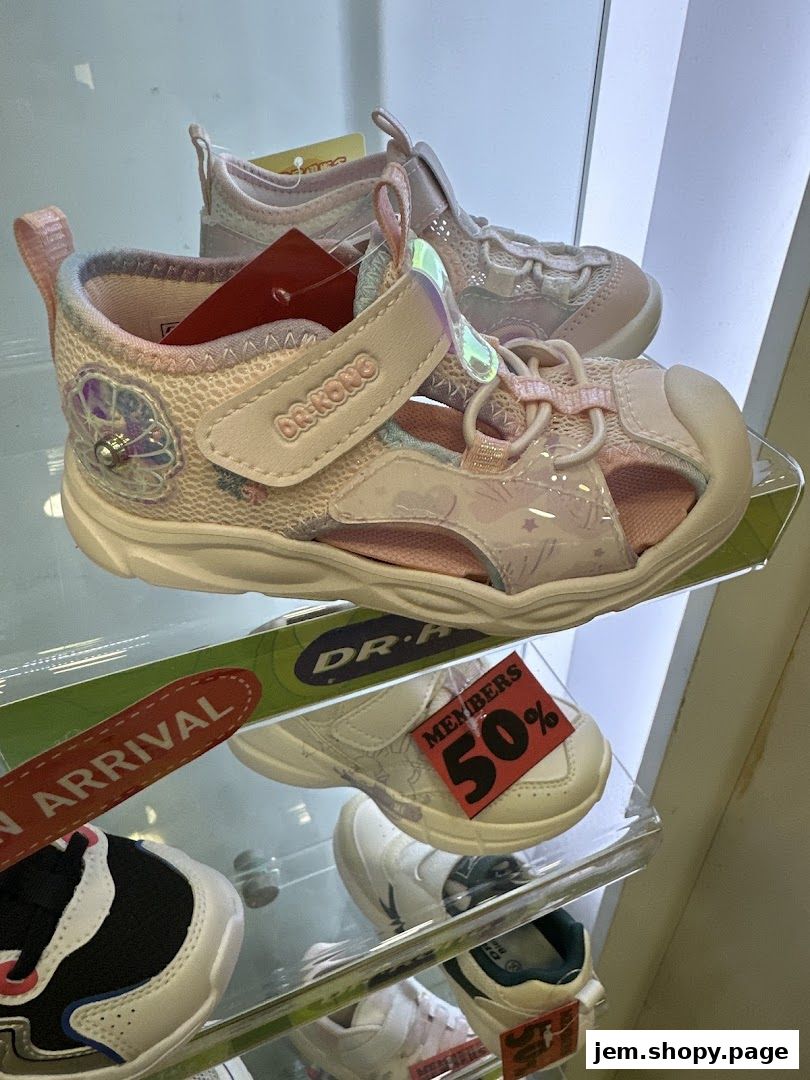 Close-up of children's sandals and shoes displayed on shelves, with sale tags visible.