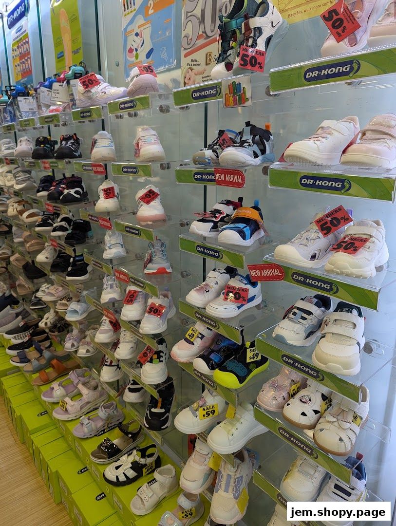 A wide selection of children's shoes displayed on shelves in a retail store.