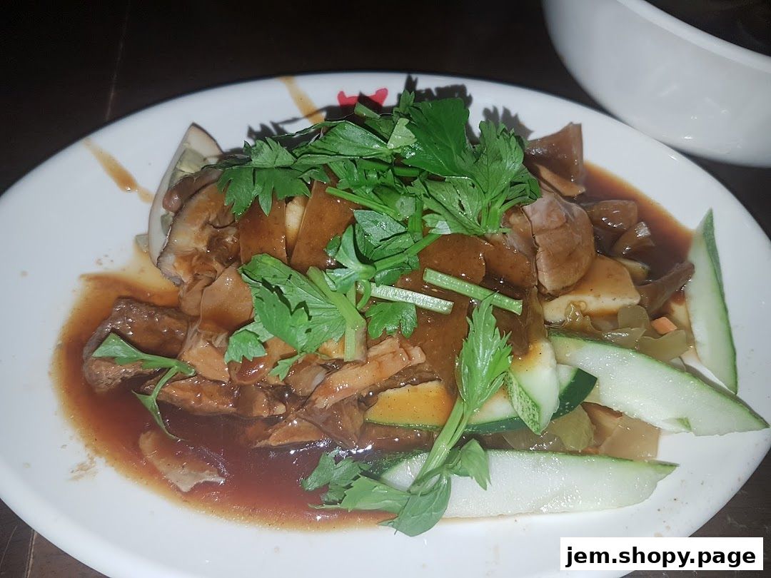 A plate of Teochew Kway Chap with braised meat, tofu, and vegetables.