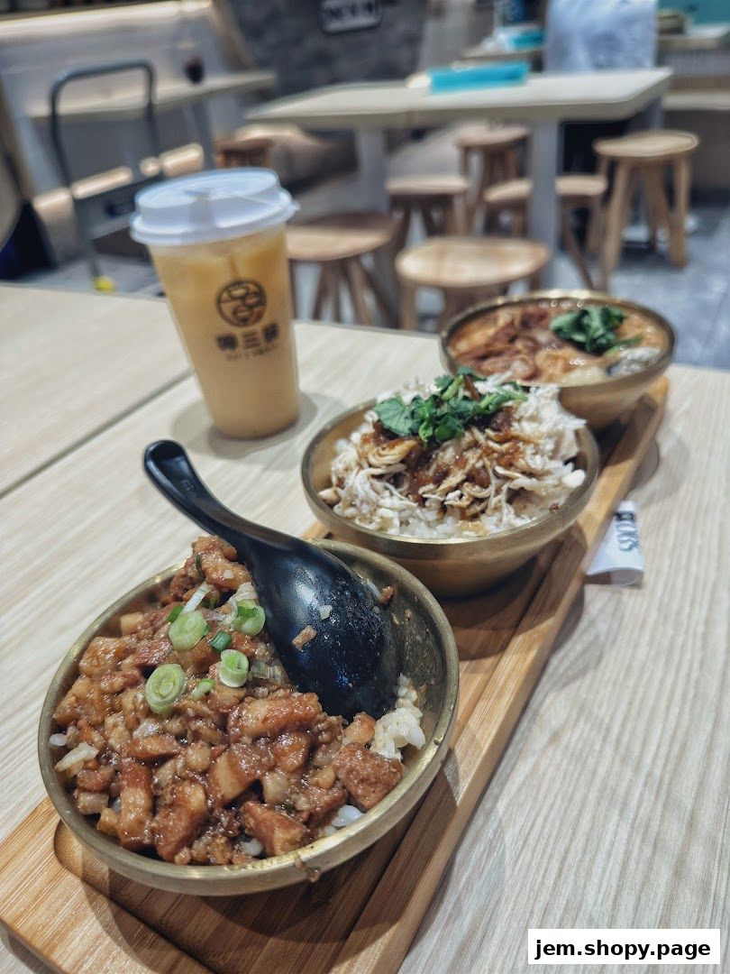 Three bowls of Taiwanese braised pork rice and chicken rice with a drink.