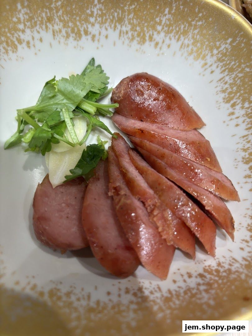 Sliced sausage with cilantro and garlic served in a decorative bowl.