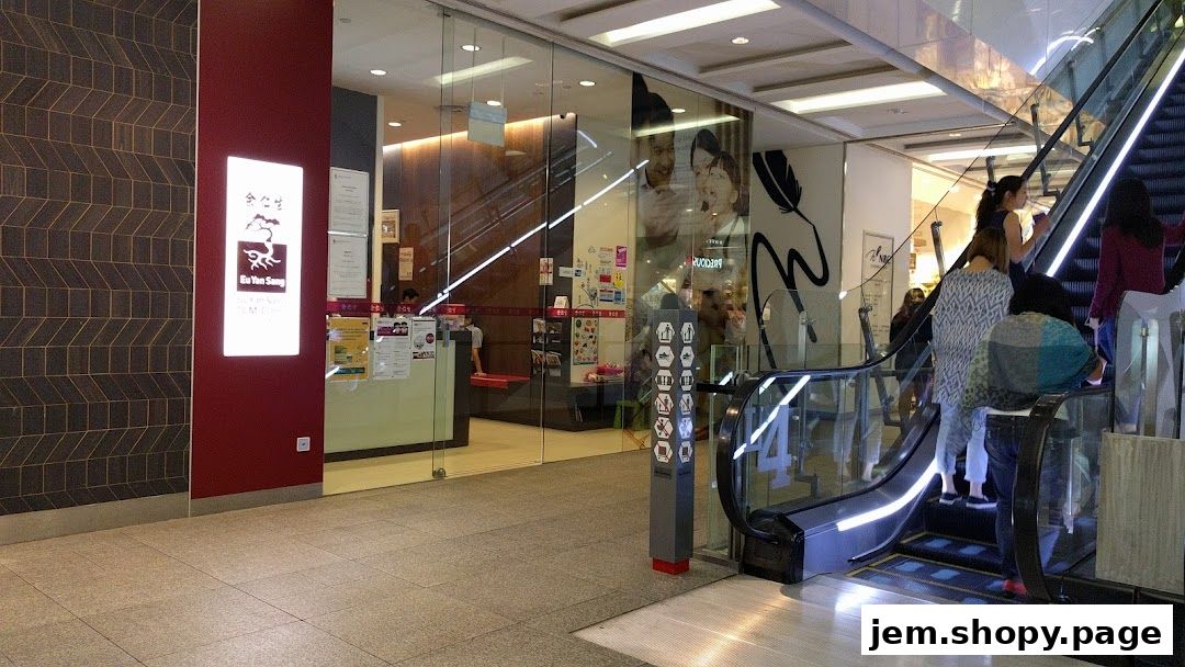 The entrance of Eu Yan Sang TCM Clinic at JEM, with a prominent sign and glass doors.