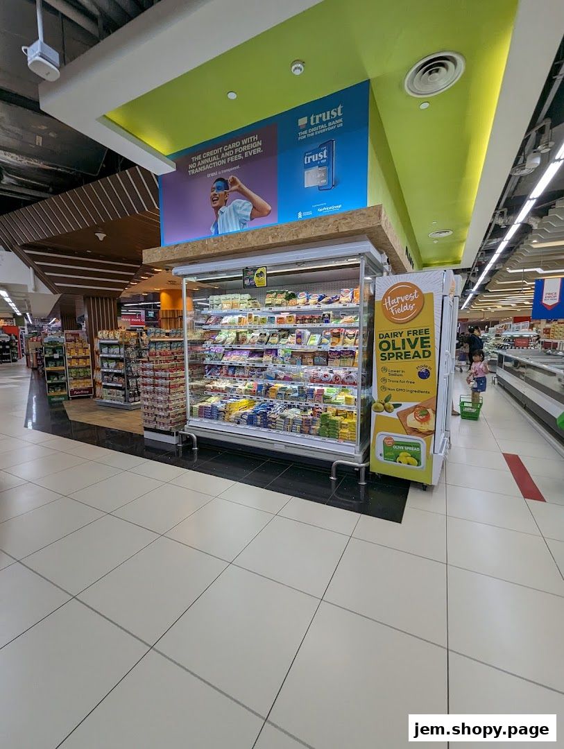 A refrigerated display case filled with dairy products inside a FairPrice Xtra supermarket.