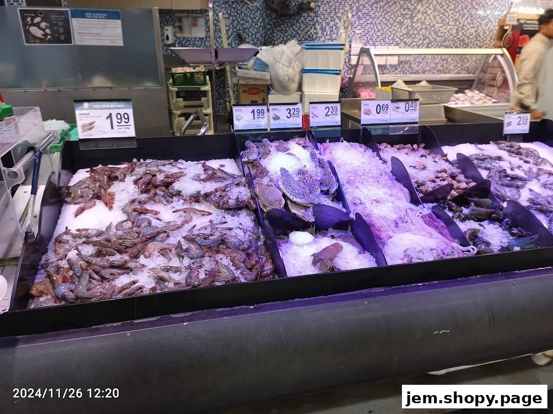 Fresh seafood display with various types of fish and shellfish on ice.