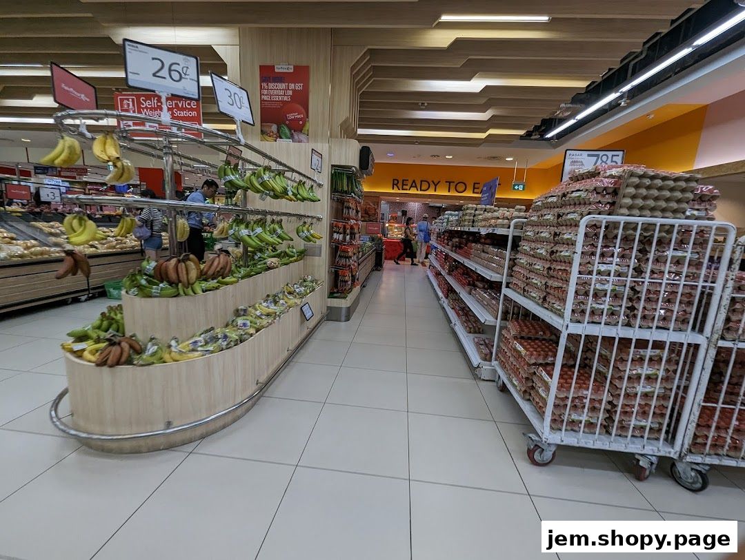 A wide aisle in a supermarket with fresh produce and stacked eggs.