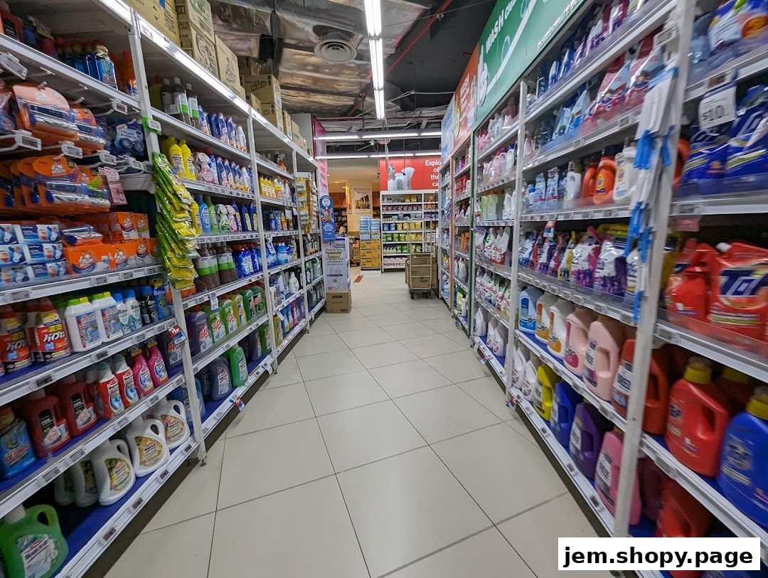 Aisle of cleaning supplies in a supermarket with shelves stocked with detergents and cleaning products.