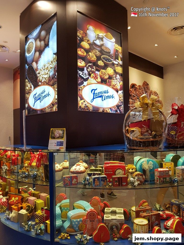 Famous Amos shop display featuring cookies, gift baskets, and festive packaging.
