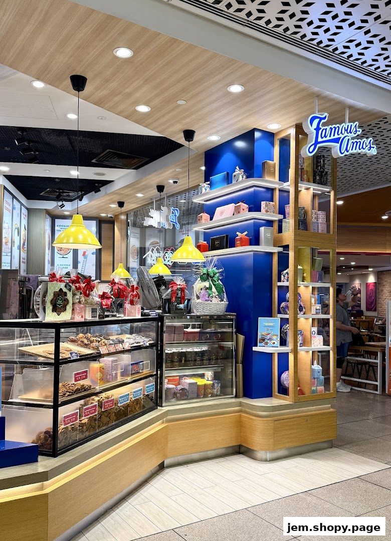 Famous Amos cookie shop interior with display cases of cookies and gift baskets.