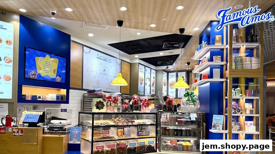 Interior view of a Famous Amos cookie shop with displays of cookies and gift boxes.