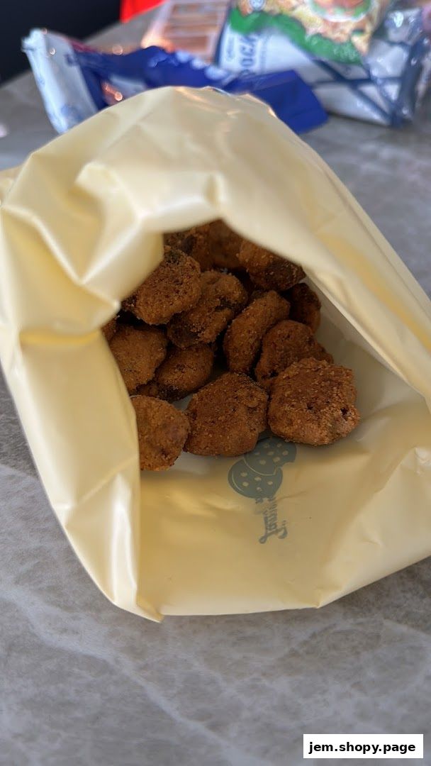 A bag of Famous Amos cookies, showing a close-up of the delicious treats inside.