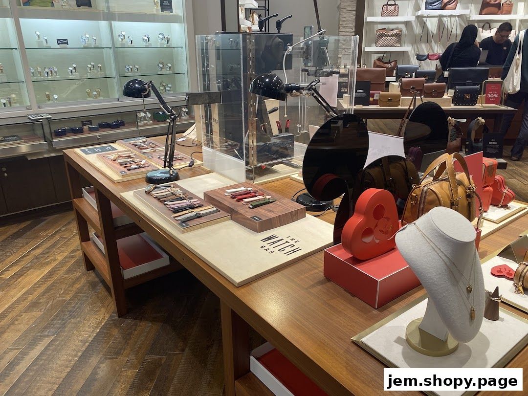 Interior view of a Fossil store showcasing watches, bags, and jewelry on display tables.
