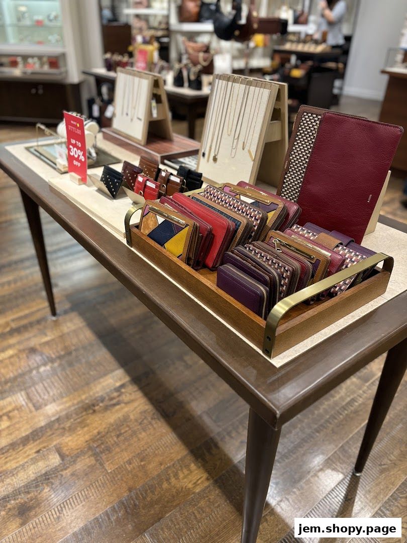 A display table showcasing Fossil wallets, cardholders, and necklaces with a sale sign.