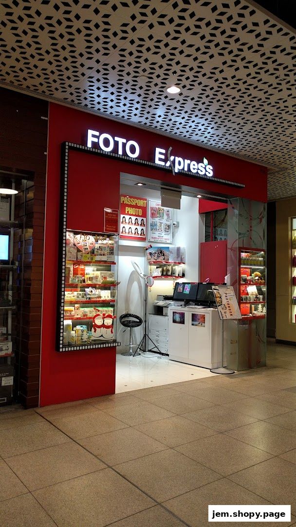 The exterior of a Foto Express shop with a red facade and display shelves.