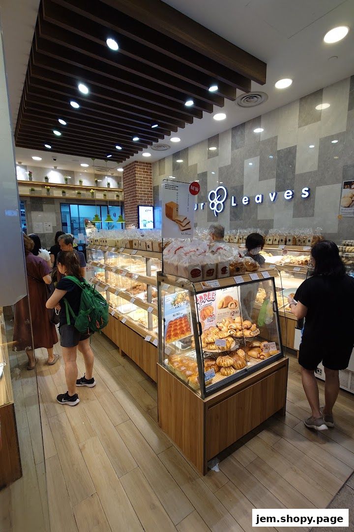 Interior view of a bakery with display cases full of bread and pastries.