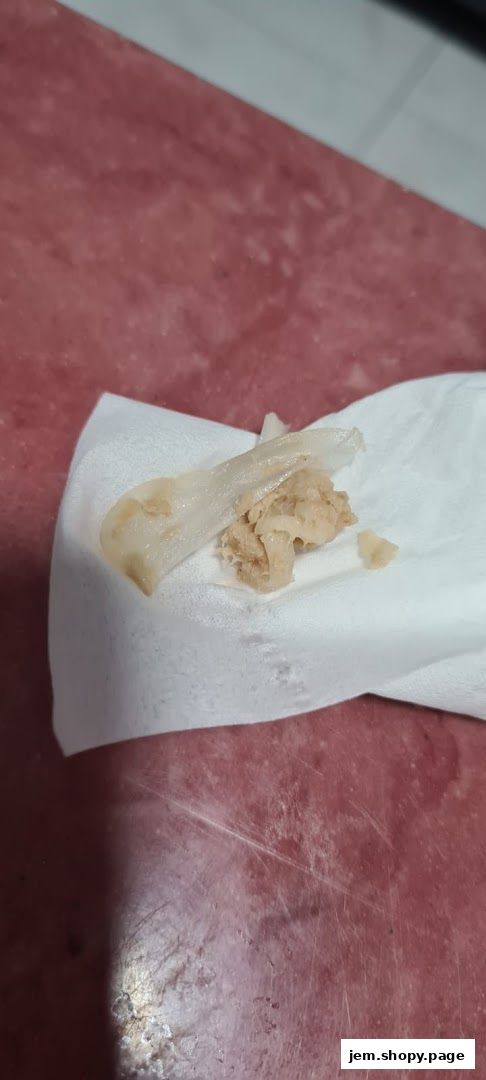 A close-up of a piece of food wrapped in a white napkin.