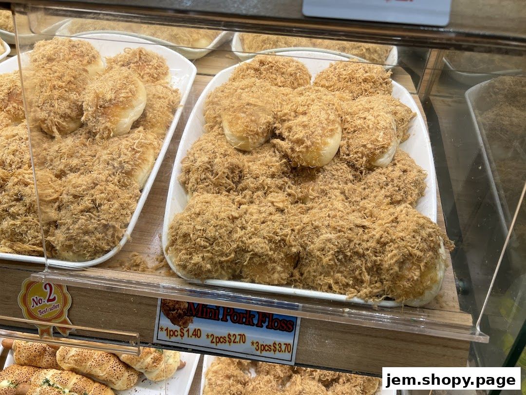 A display of freshly baked buns topped generously with shredded pork floss.