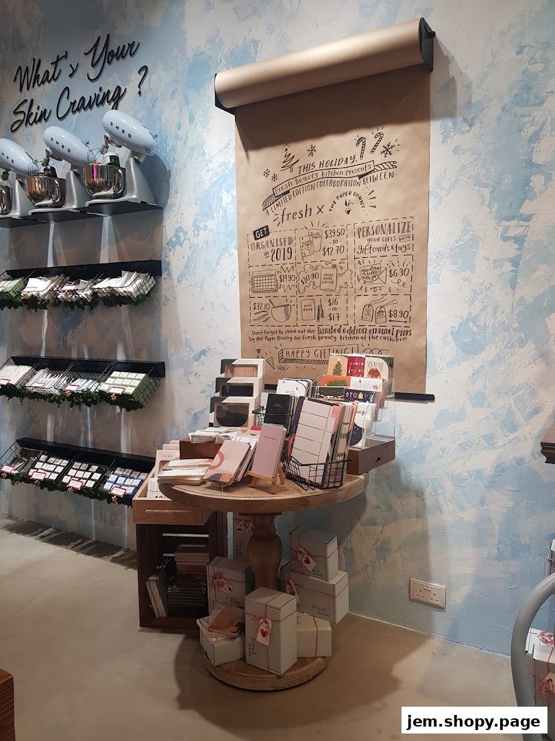 A retail display featuring skincare products, stationery, and gift items with holiday-themed decorations.