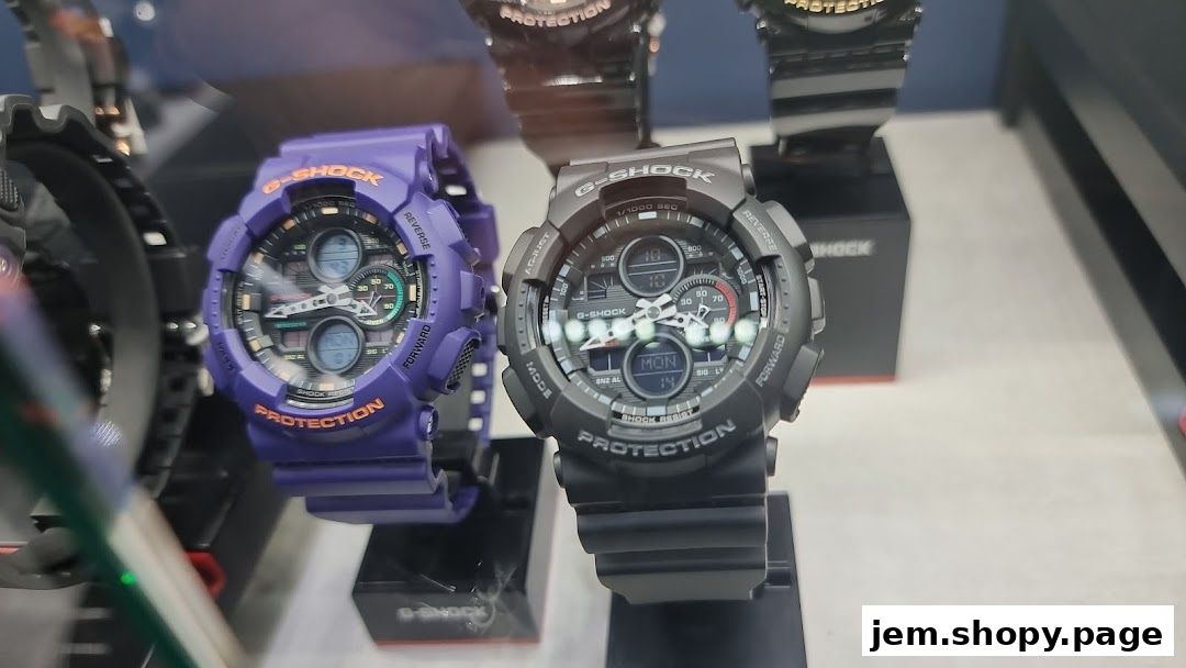 Close-up of G-SHOCK watches, one purple and one black, displayed in a shop.