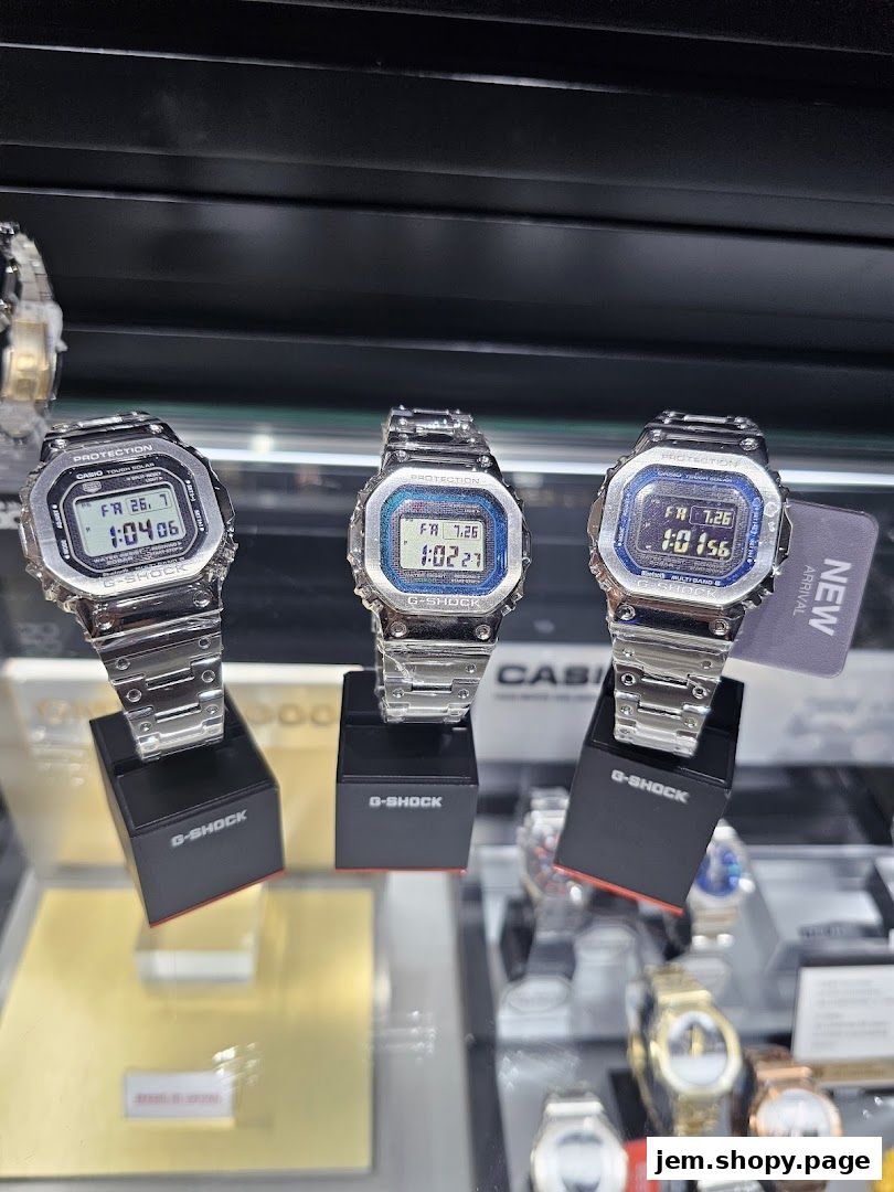 Three G-SHOCK watches displayed on stands in a retail store.
