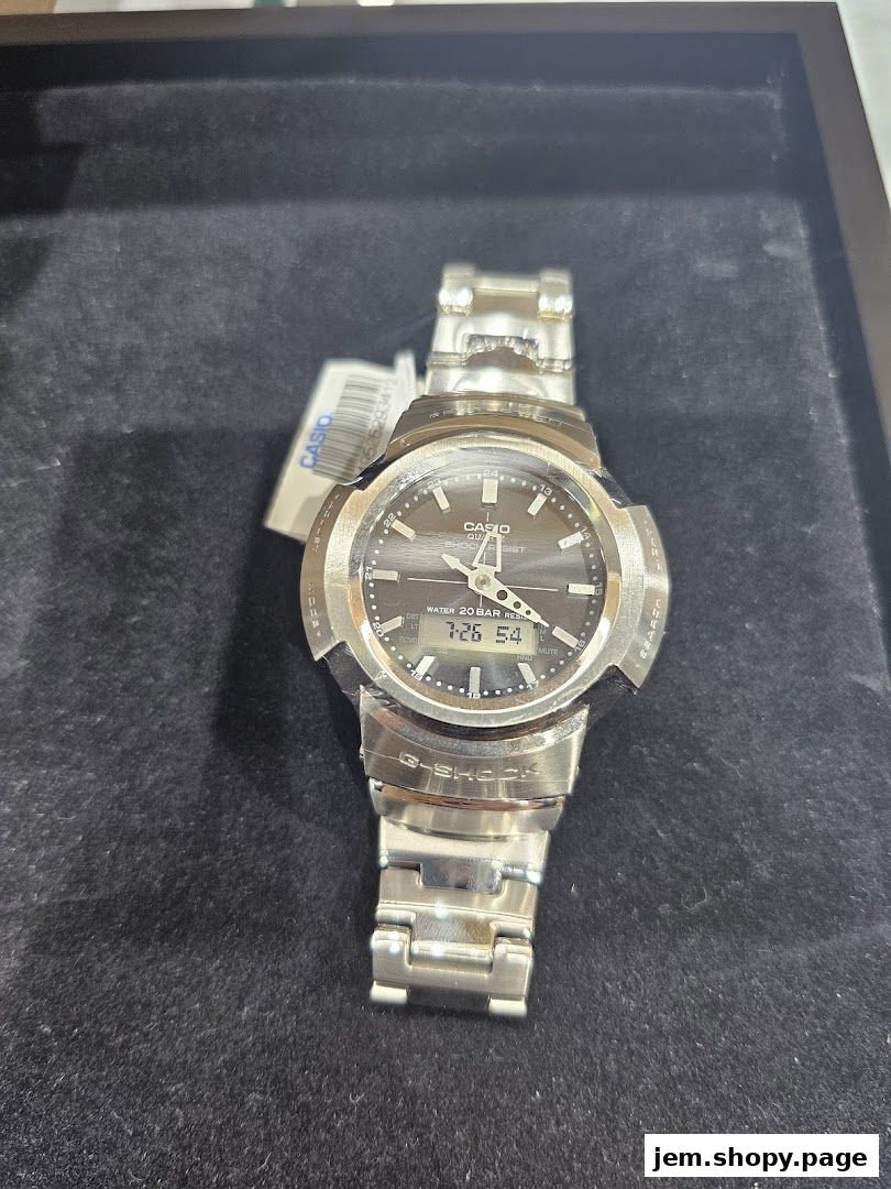 A close-up shot of a silver G-SHOCK CASIO watch with a dark dial.