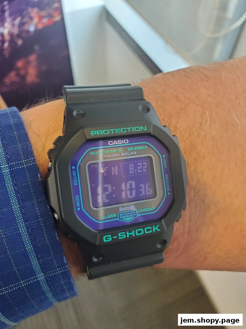 A person wearing a black G-SHOCK CASIO watch with a digital display.