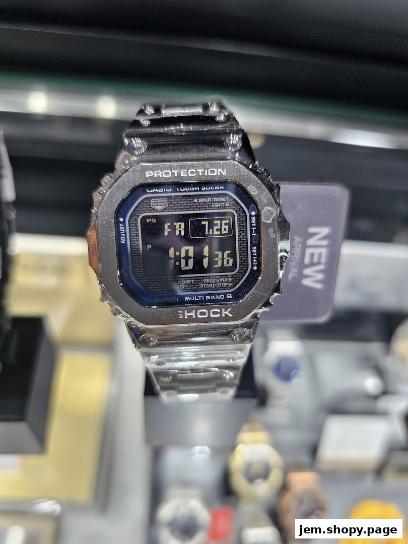 A close-up of a G-SHOCK CASIO watch with a metallic band and digital display.