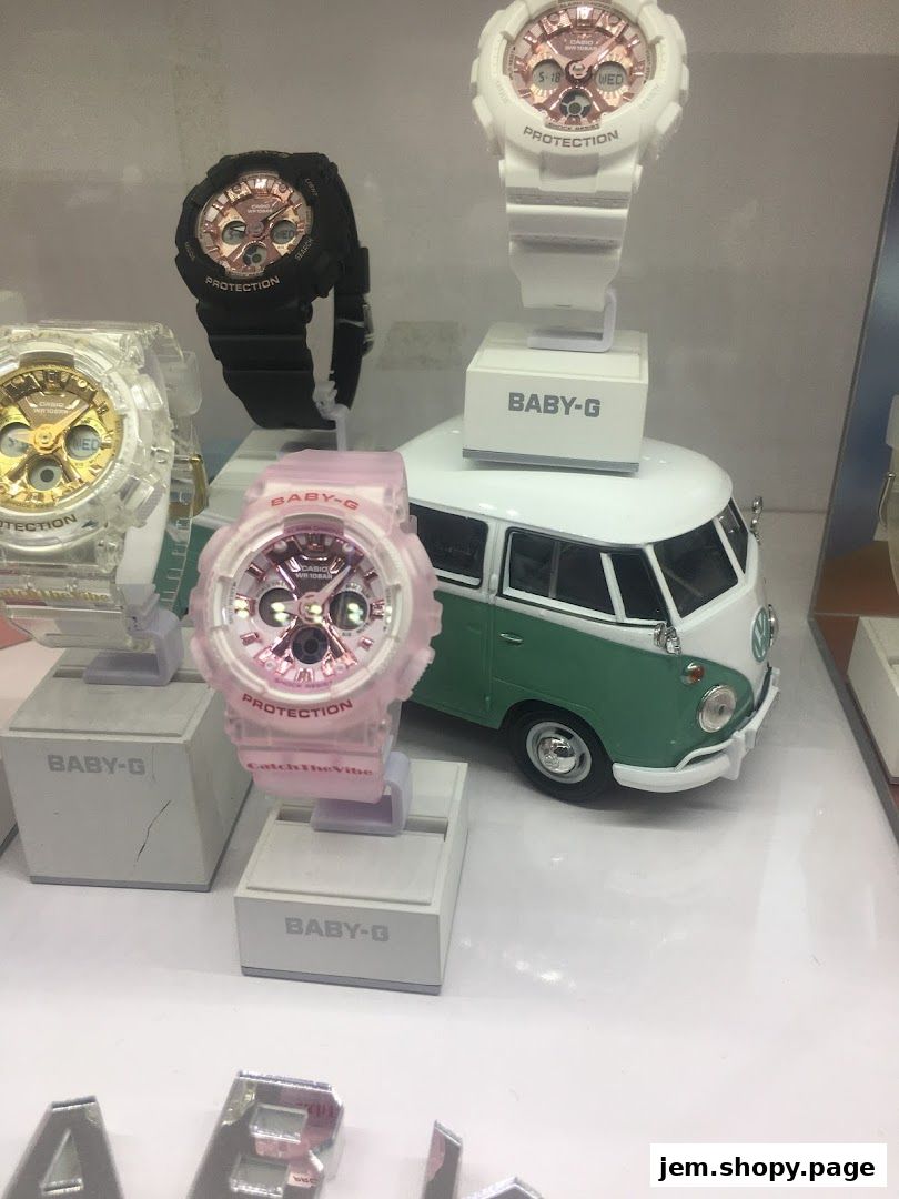 Display of various G-SHOCK and BABY-G watches with a vintage camper van model.