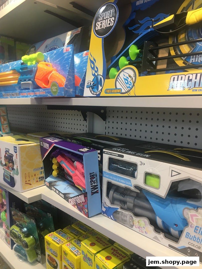 Shelves stocked with various toy guns, including water guns, crossbows, and bubble guns.