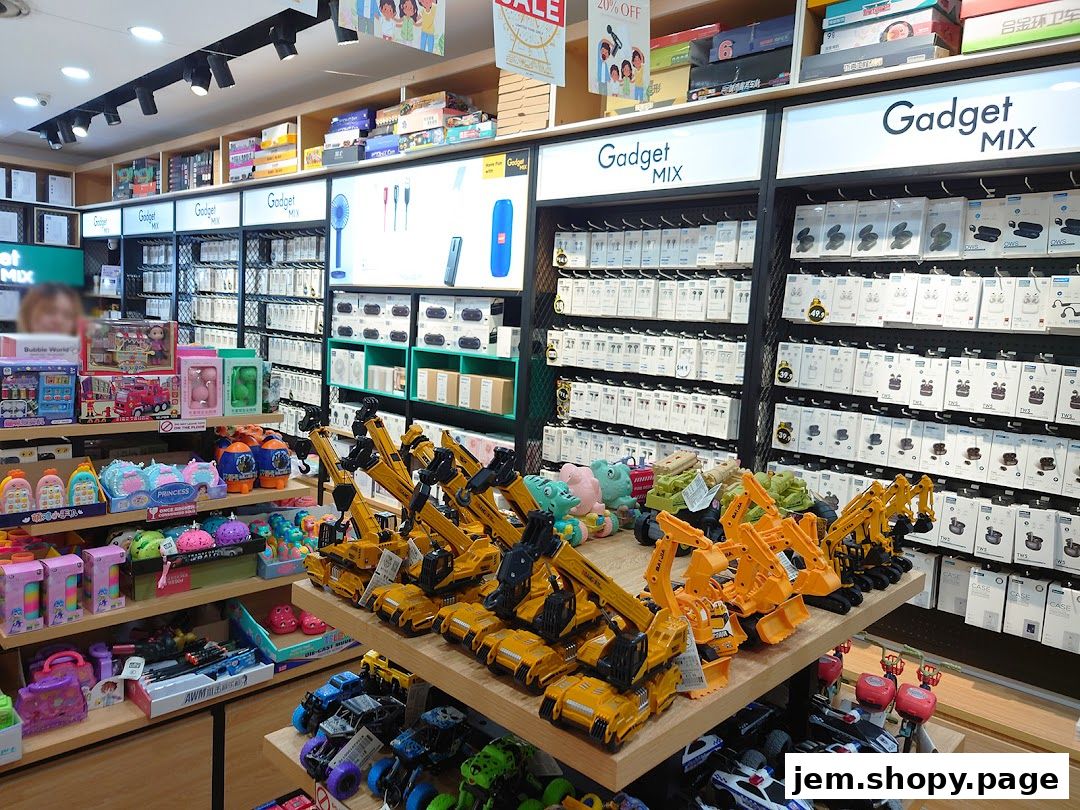 Interior view of Gadget Mix store showcasing electronics, toys, and accessories on shelves and display tables.
