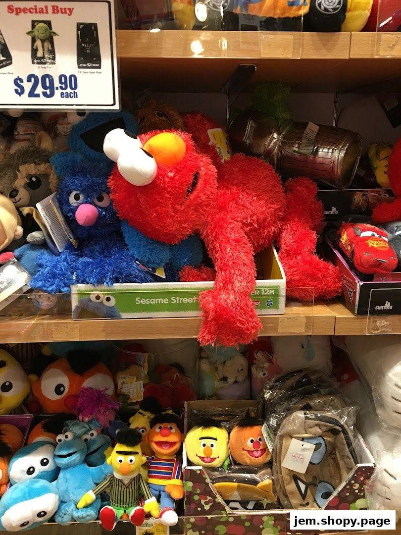 A display of plush toys including Sesame Street characters and Star Wars figures.
