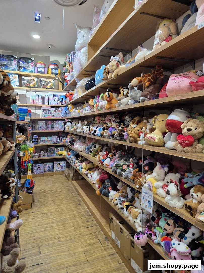 A wide selection of plush toys and stuffed animals displayed on shelves in a retail store.