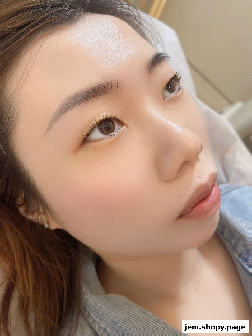 Close-up of a woman's face with perfectly shaped eyebrows and long lashes.