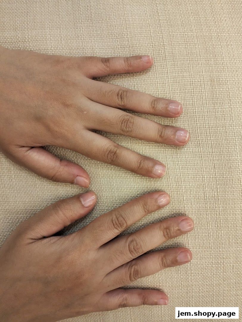 Close-up of two hands with neatly manicured, natural-looking nails.