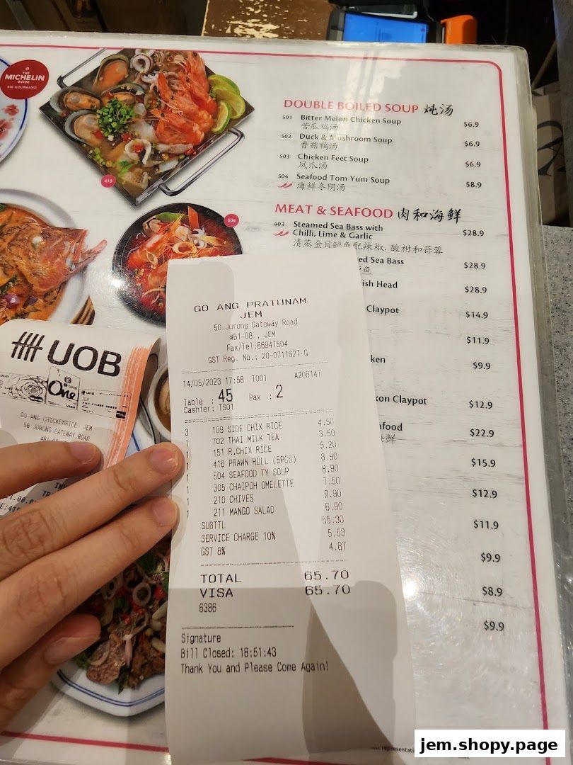A menu and receipt from Go-Ang Pratunam Chicken Rice, featuring various dishes and payment details.
