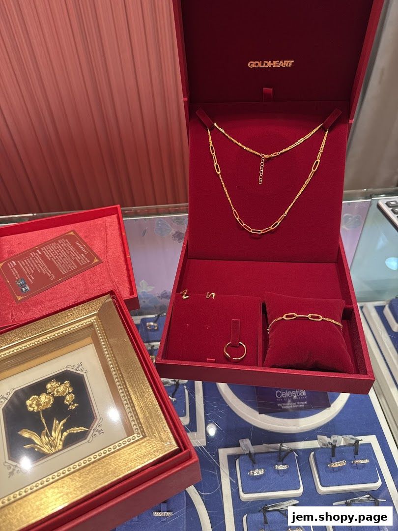 Gold jewelry displayed in red velvet boxes, including necklaces, bracelets, and rings.
