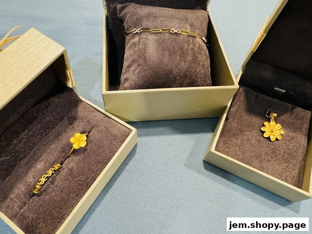 Three elegant gold jewelry pieces displayed in open gift boxes.